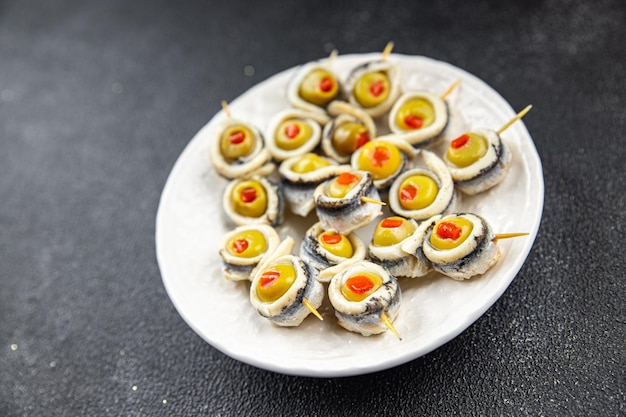 Foto oliva in filetto di acciughe rotolo di acciughe olive ripiene appetitoso antipasto di pesce marinato