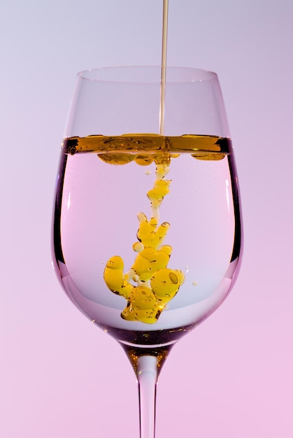 Olive oil being poured into wine glass