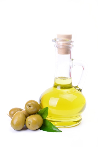 Olive oil in a bottle and fresh green olives