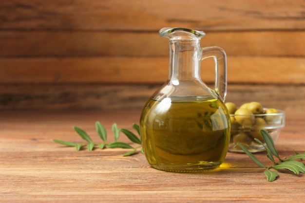 Olive oil green leaves and olives on the table