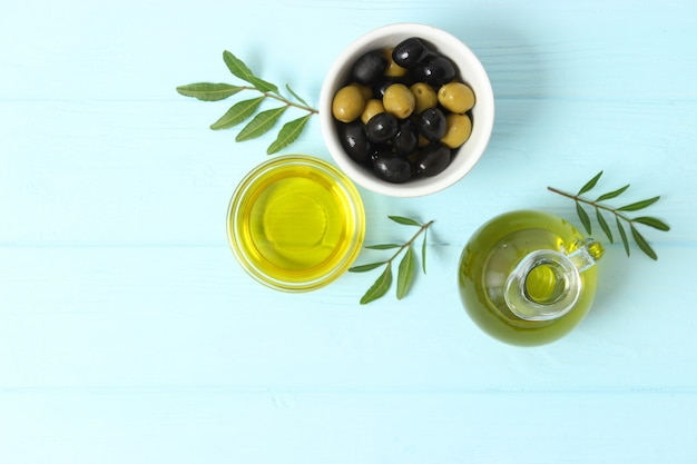 Olive oil green leaves and olives on the table