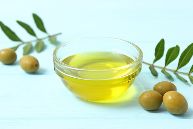 Olive oil green leaves and olives on the table