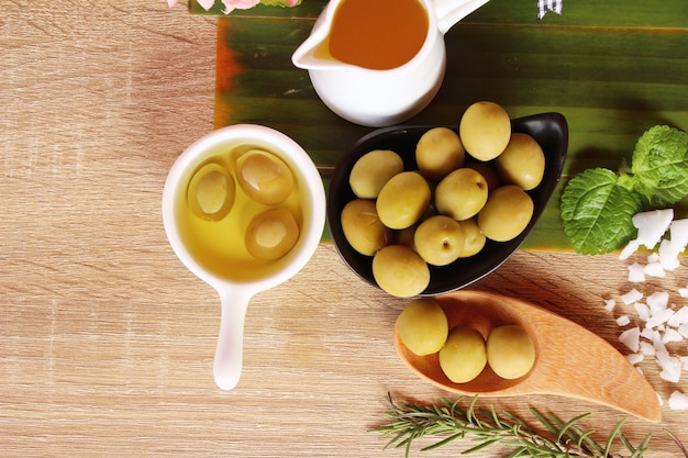 Olive oil for health on wood background