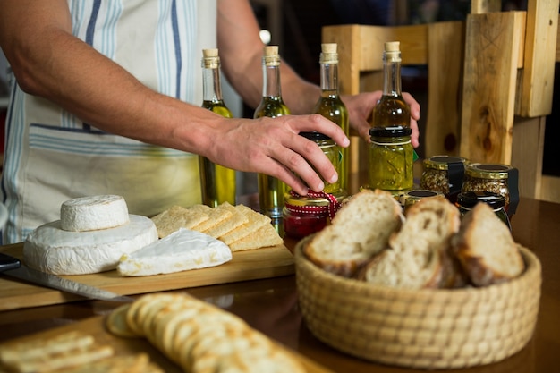 olive oil, jam, pickle placed together on table