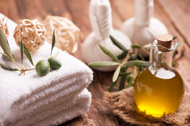 Olive oil soap and bath towel on wooden table