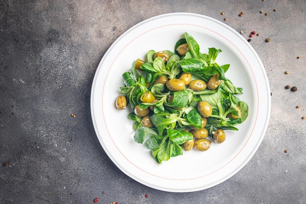 Olive salad, leaf lettuce, mache corn lettuce fresh healthy meal food snack diet on the table