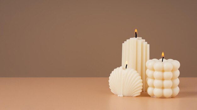 Olive wax burning candle on a beige sustainability candle natural materials copy spacehorizontal