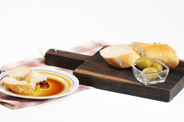 Olives, baguette and olive oil