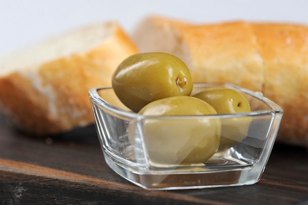 Olives, baguette and olive oil