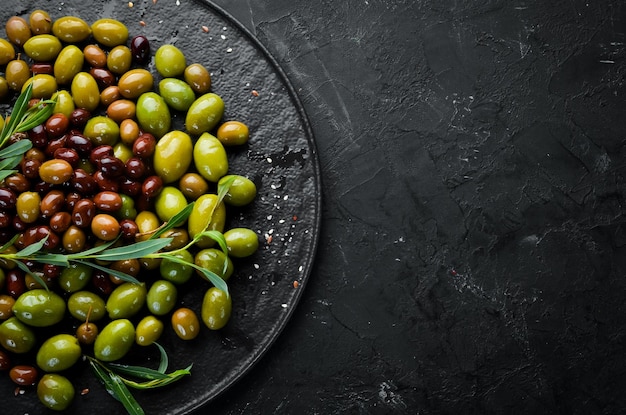 Olives in a bowl olive oil spices and herbs Top view Free space for your text