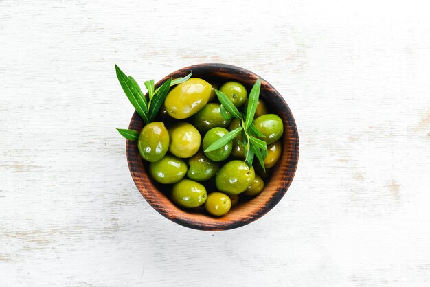 Olives in a bowl olive oil spices and herbs Top view Free space for your text