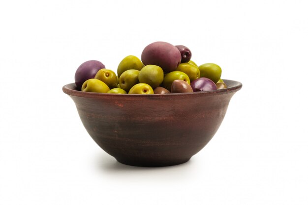 Olives in ceramic brown bowl isolated on white