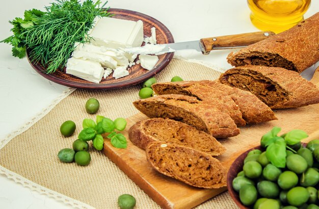 Olives and cheese on a white background. sandwiches. selective focus.