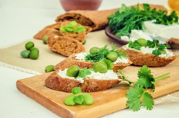 Olives and cheese on a white background. sandwiches. selective focus.