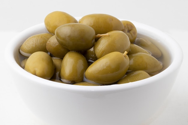 Olives in a white bowl close up