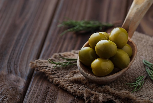 Olives in wooden spoon