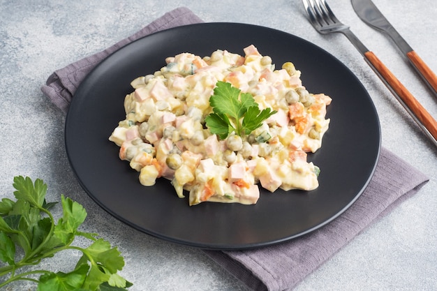 Olivier salad with mayonnaise on a plate