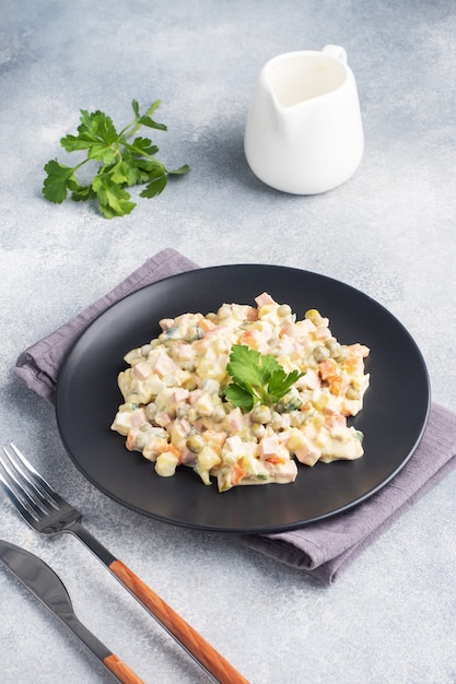 Olivier salad with mayonnaise on a plate