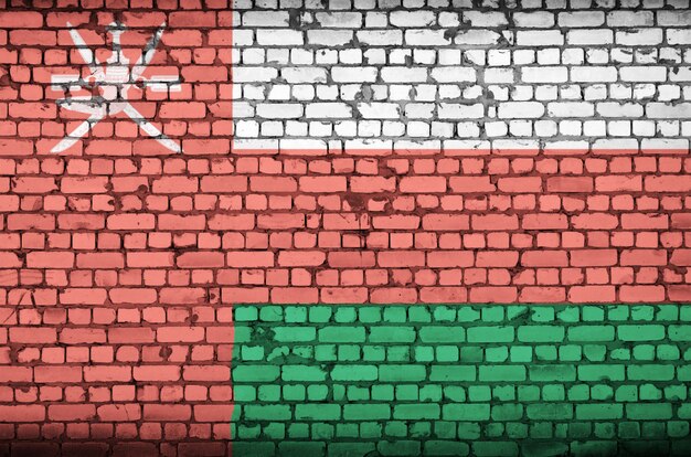 Oman flag is painted onto an old brick wall