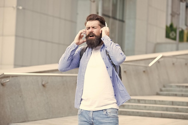 Omdat de straten zingen Gelukkige hipster zingt lied stedelijk buitenshuis Bebaarde man geniet van zingen in een koptelefoon Vocale en zangstem Voel en beleef de muziek die je zingt