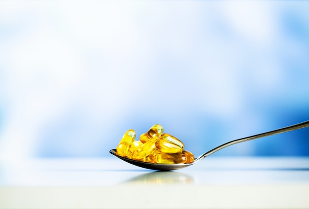 Omega 3 fish oil yellow soft gel capsules.