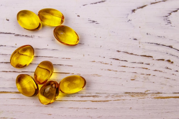 Omega 3 pills on a white wooden table