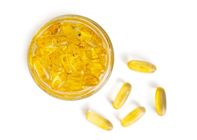 Omega 3 yellow capsules in glass bottle isolated on white background