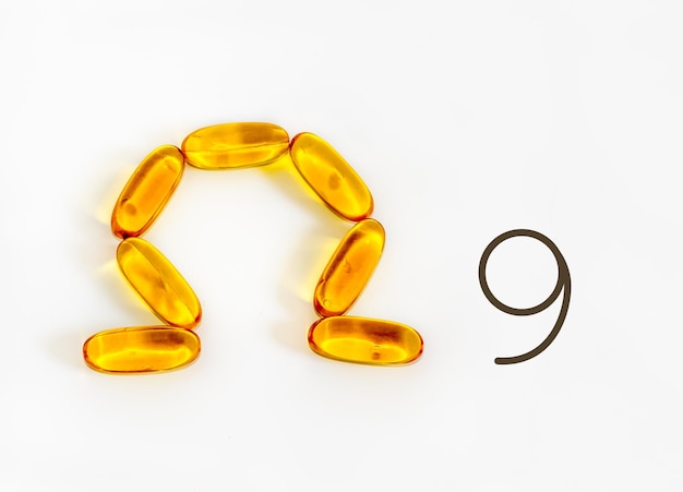 Omega-9 fatty acid symbol, essential oils, soft gels on white background