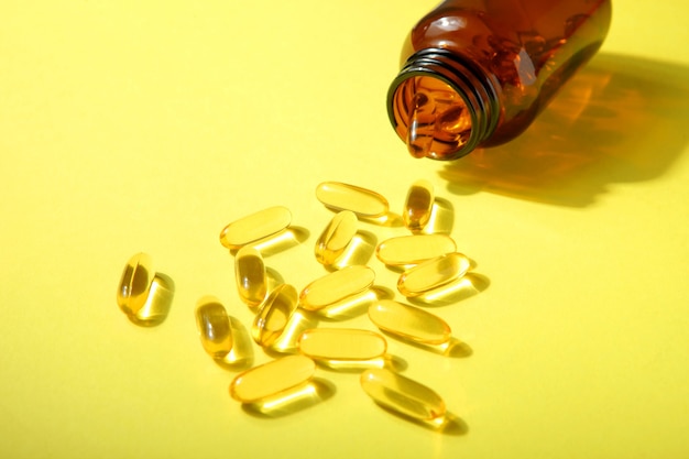 Photo omega  capsules on a colored background closeup with place for text