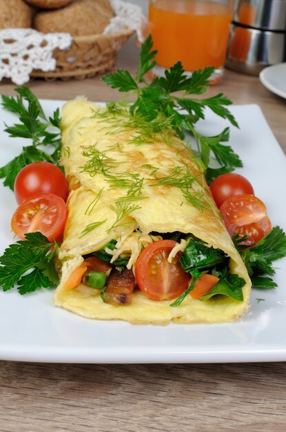 Omelet gevuld met groenten, kruiden en tomaten