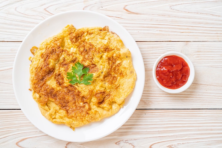 Photo omelet or omelette with ketchup