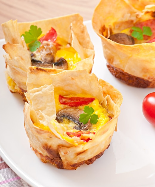 Omelet in pita bread with tomato, bacon and mushrooms