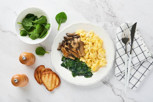 Omelet Spinach oyster mushroom and cheese omelet or frittata on white marble background Breakfast idea Top view with copy space