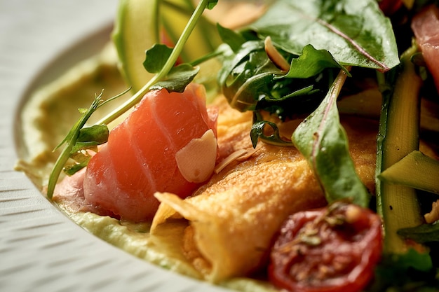 Omelet with avocado mousse and salmon in a plate Selective Focus Noise in postproduction