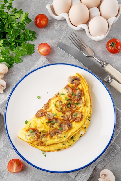 Omelet with fried mushrooms and fresh herbs in a plate Delicious healthy breakfast Copy space