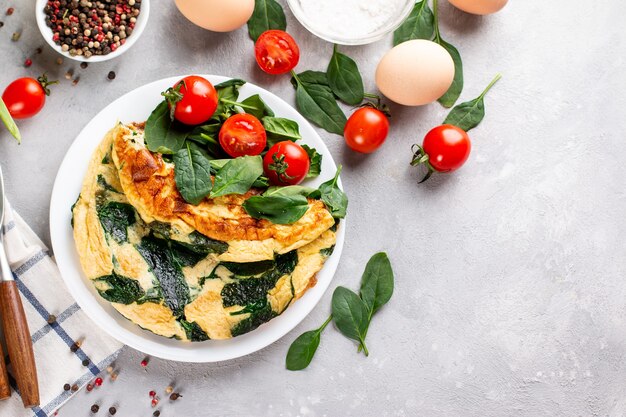 Omelet with spinach leaves