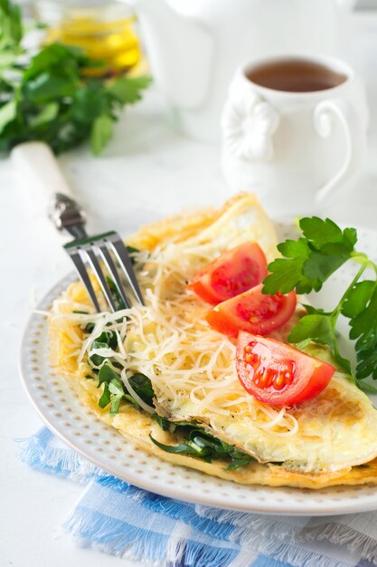 Omelet with spinach, parsley and cheese for breakfast.