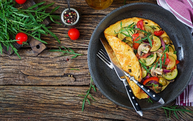 Omelet with tomatoes, zucchini and mushrooms. Omelette breakfast. 