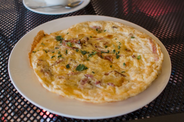 Omelet with vegetables on a plate on the table