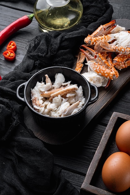 Omelette ingredients with pepper crab meat egg cheese on black wooden table background