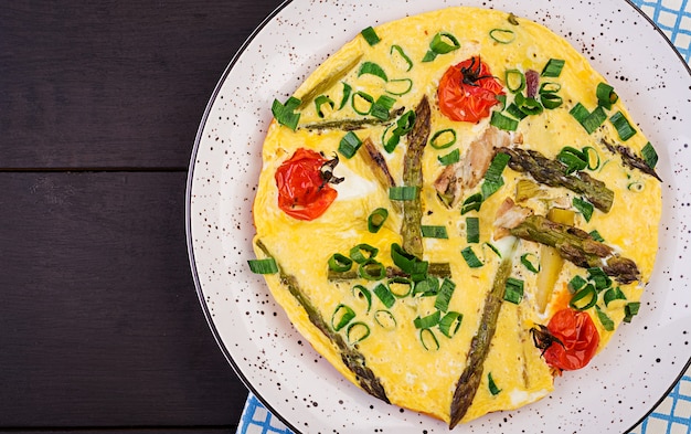 Omelette with asparagus and tomato for breakfast