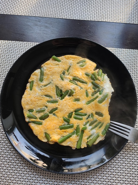 Omelette with green beans on the table