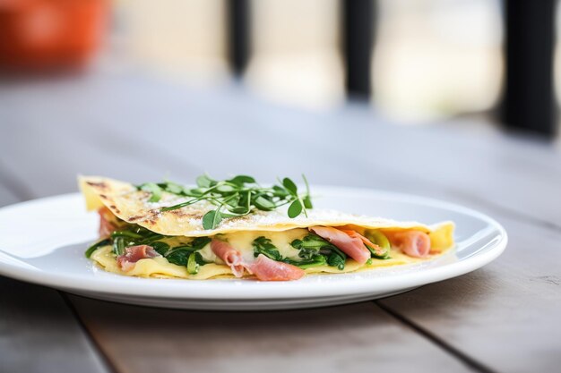 Photo omelette with ham and spinach halffolded