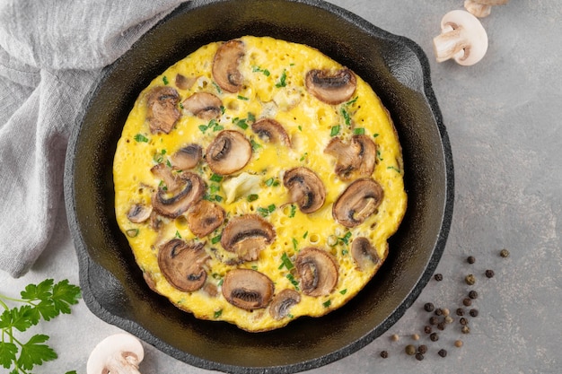 Omelette with mushrooms and herbs in a pan  Healthy breakfast Top view Copy space