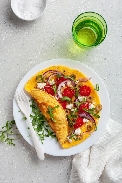 Omelette with tomato feta cheese onion and arugula healthy keto diet low carb breakfast
