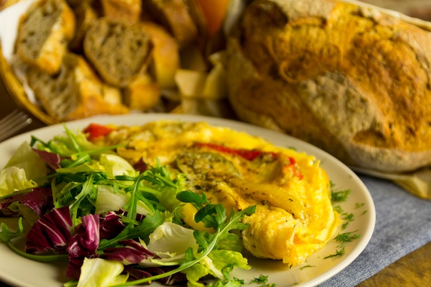 Omelette with vegetables and lettuce bread and orange juice breakfast