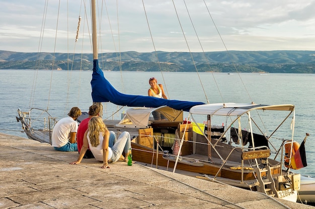 Omis, Croatia - August 17, 2016: Friends relaxing on the Boat at the harbor in the Adriatic Sea in Omis, Croatia