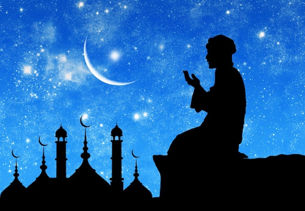 Ãâ¡oncept of the islamic religion. silhouette of the town hall and praying men on the background of the starry sky and the moon