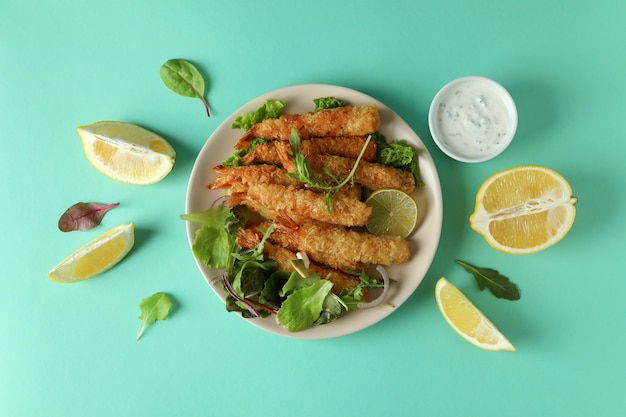 ÃÂ¡oncept of tasty food with deep-fried shrimp on mint background