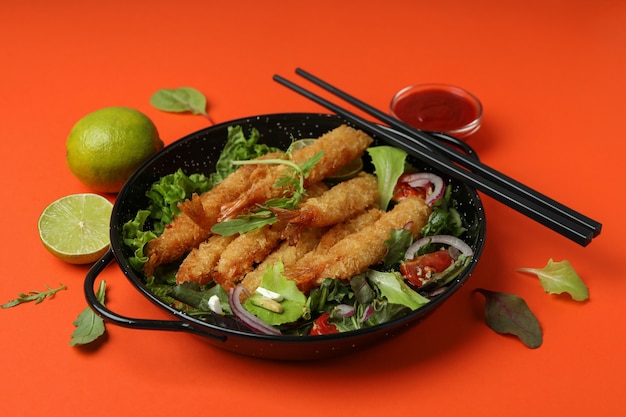 ÃÂ¡oncept of tasty food with deep-fried shrimp on orange background